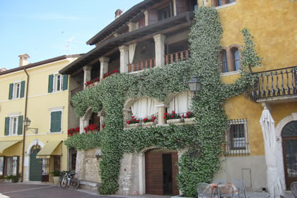 Torri del Benaco the flowery facade of the house on the harbor